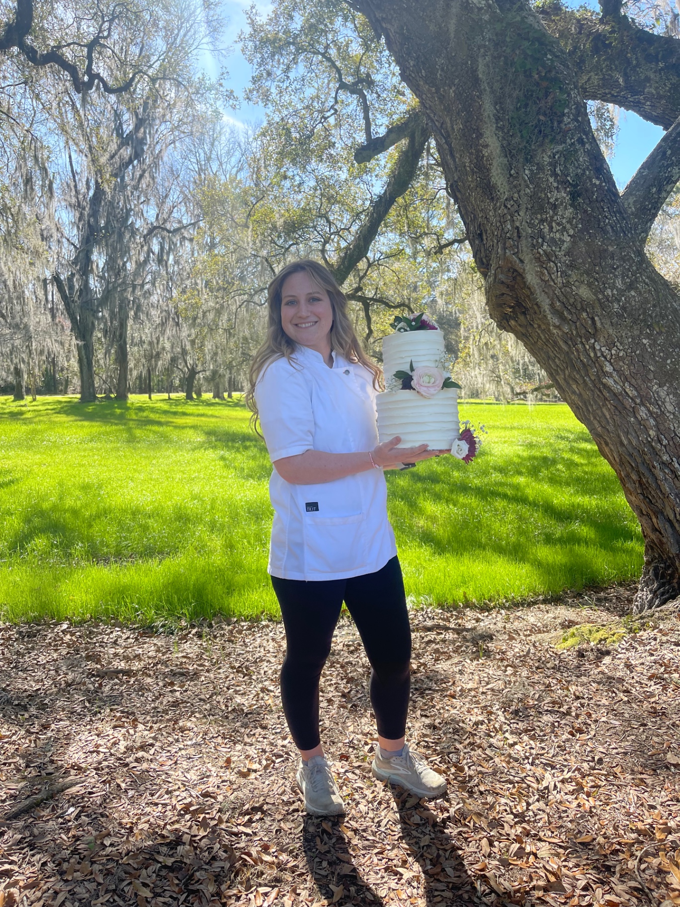 Alexandra Kowaleski holding a finished cake in Charleston